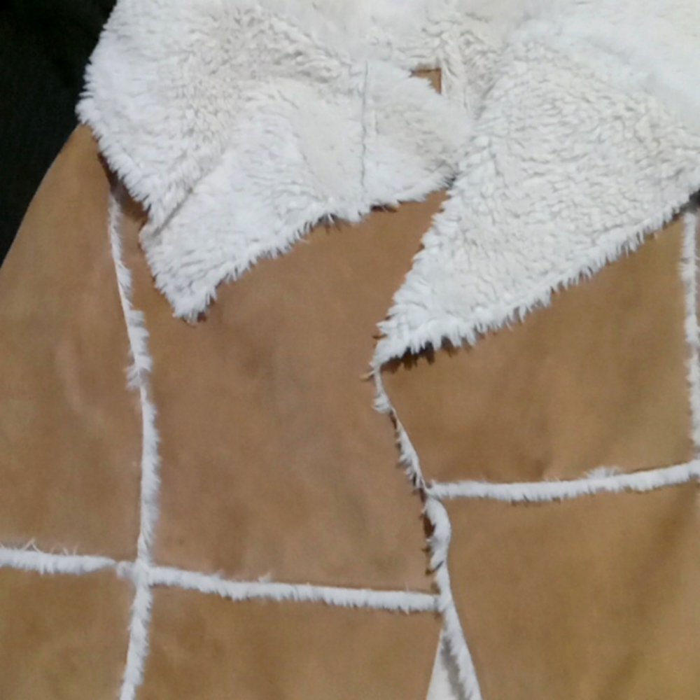 A woman's poncho sheep skin jacket